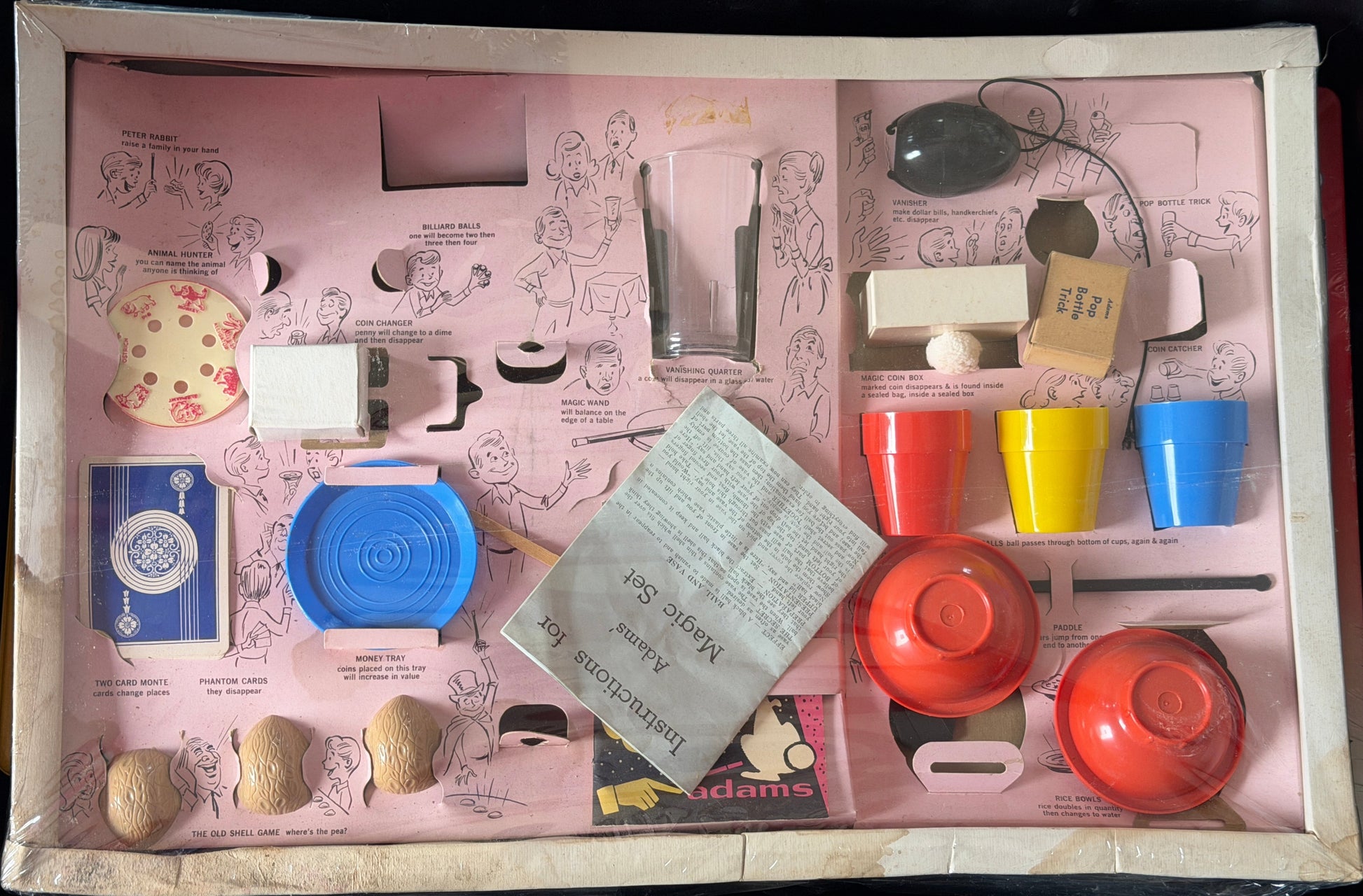Toy kitchen set with various items on a pink tray