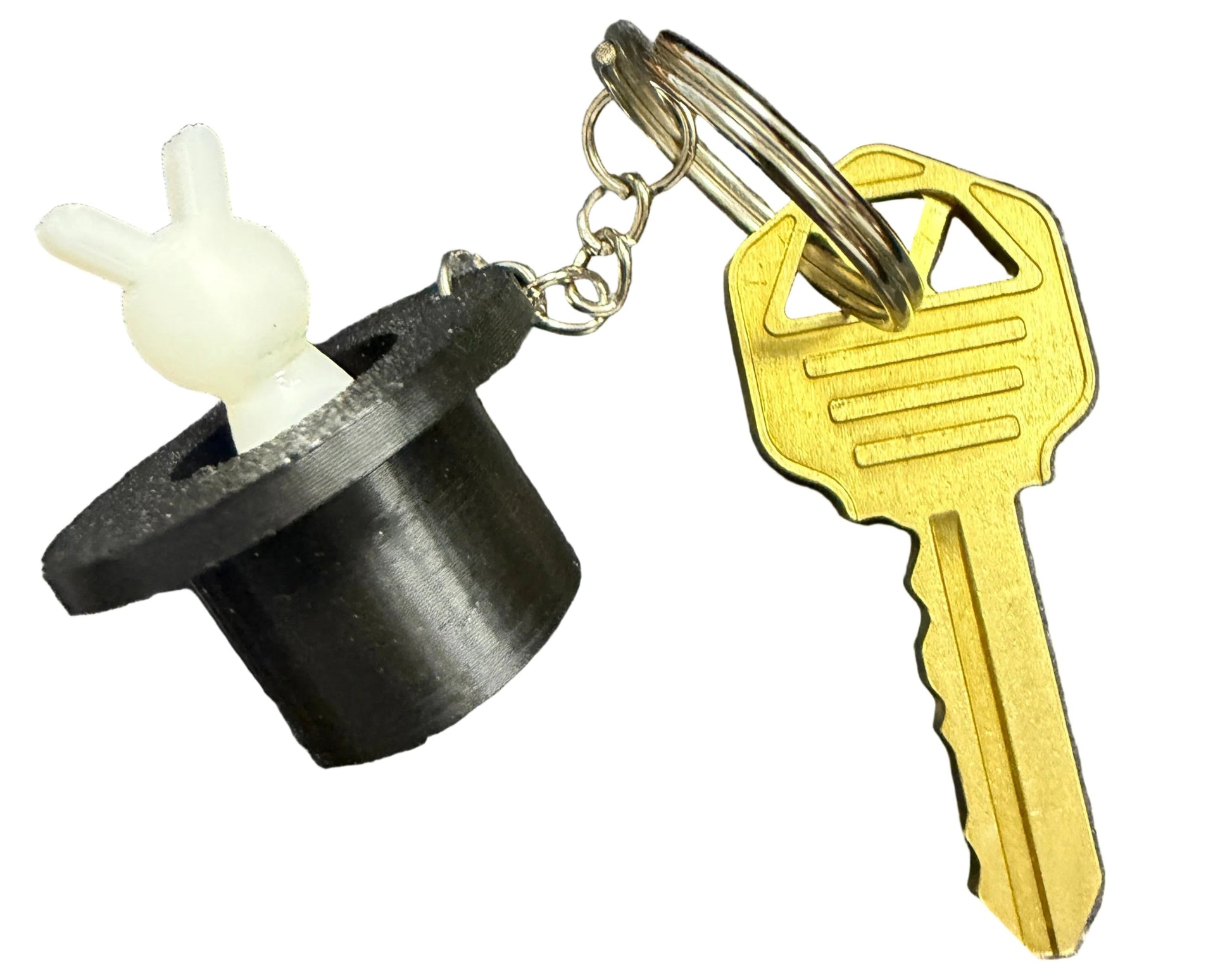 Keychain with a key and a black and white object on a map background