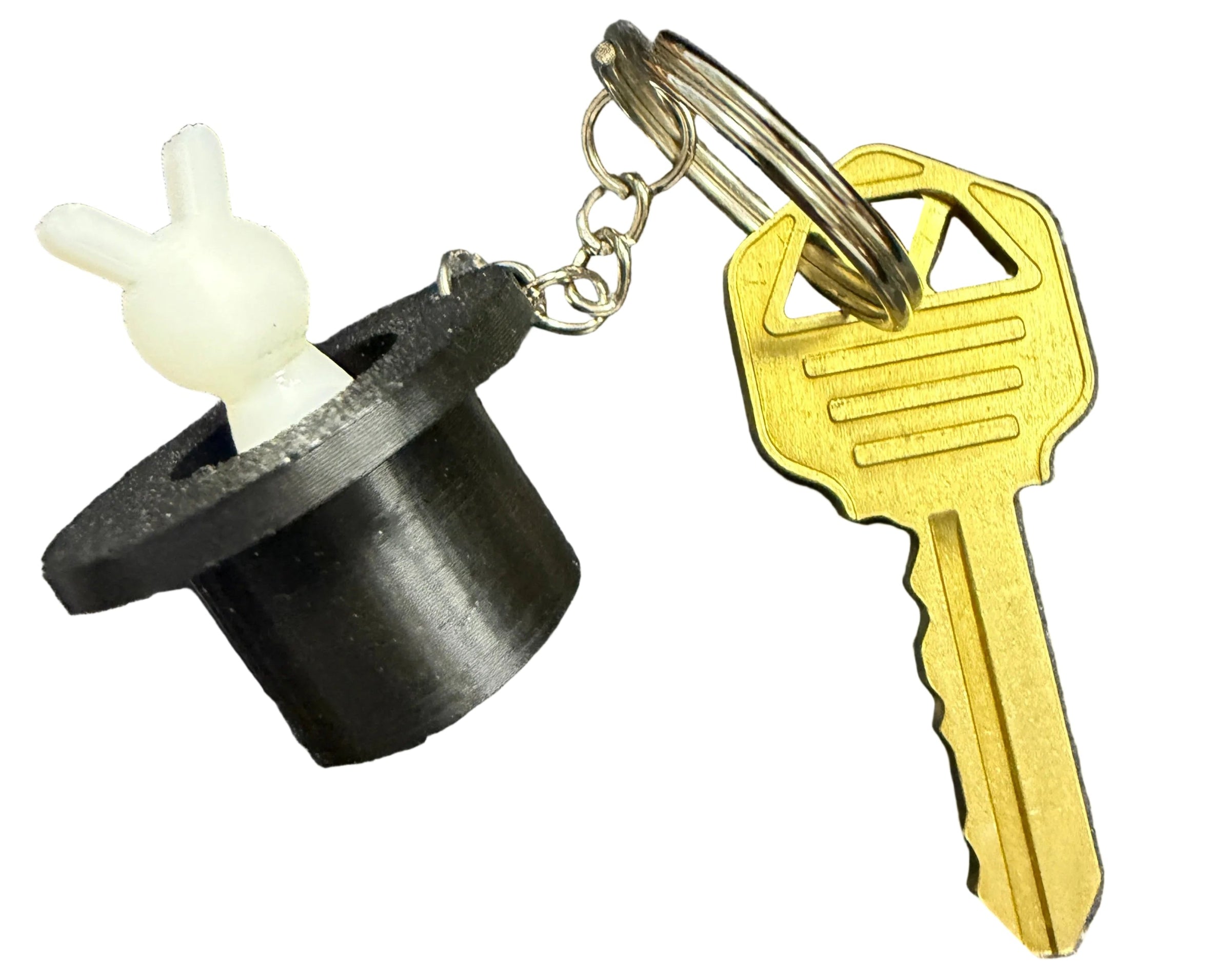 Keychain with a key and a black and white object on a map background