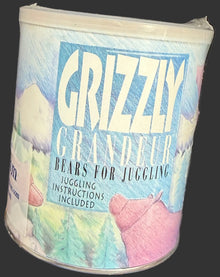 Colorful cylindrical container labeled 'Grizzly' on a desk with a keyboard and map.