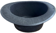 Black bowl on a cluttered desk with office supplies and a can of pop.