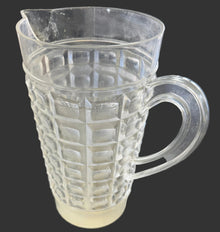 Clear plastic filter attached to a machine on a gray surface