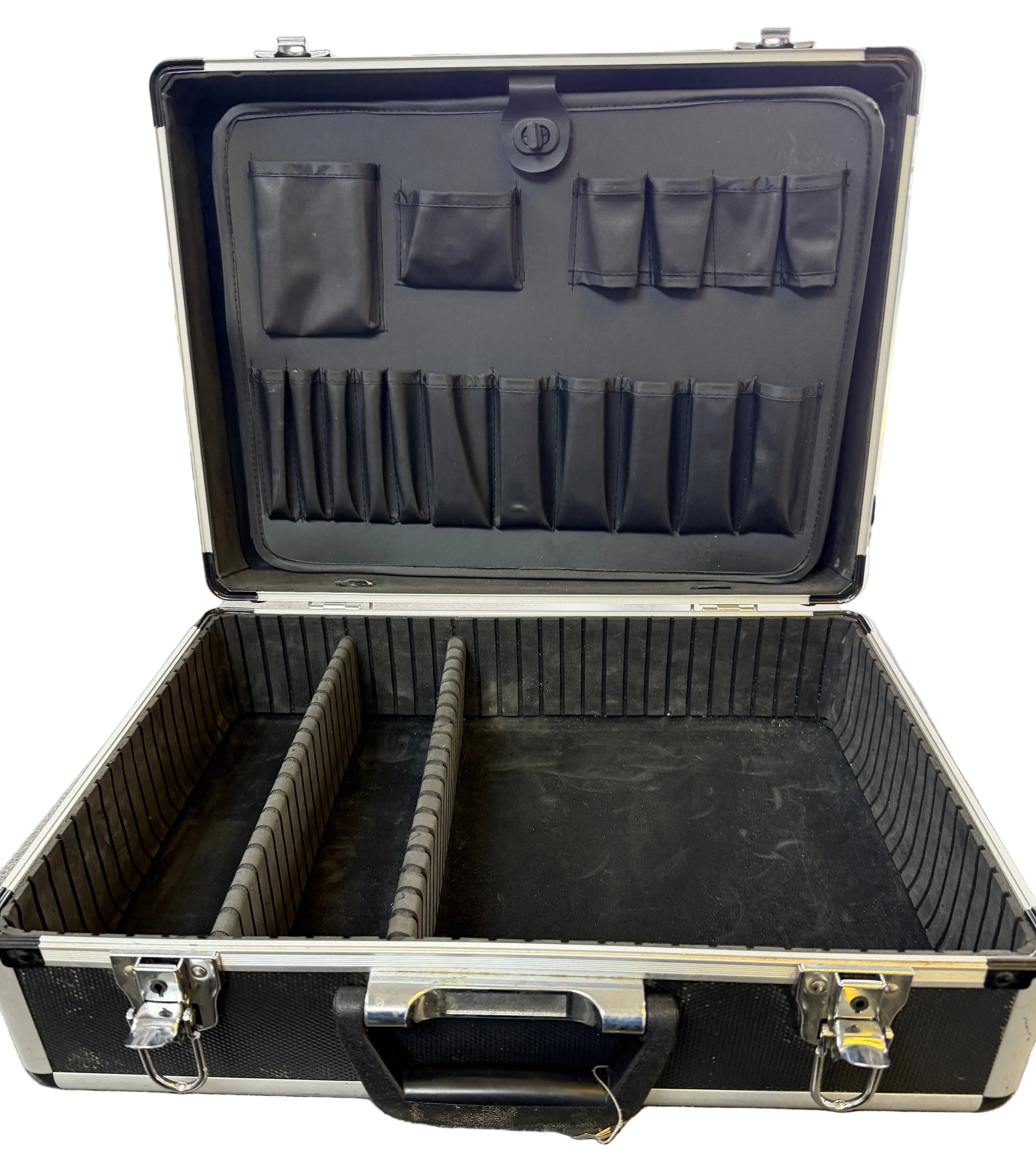 Open black tool case with compartments on a gray floor.