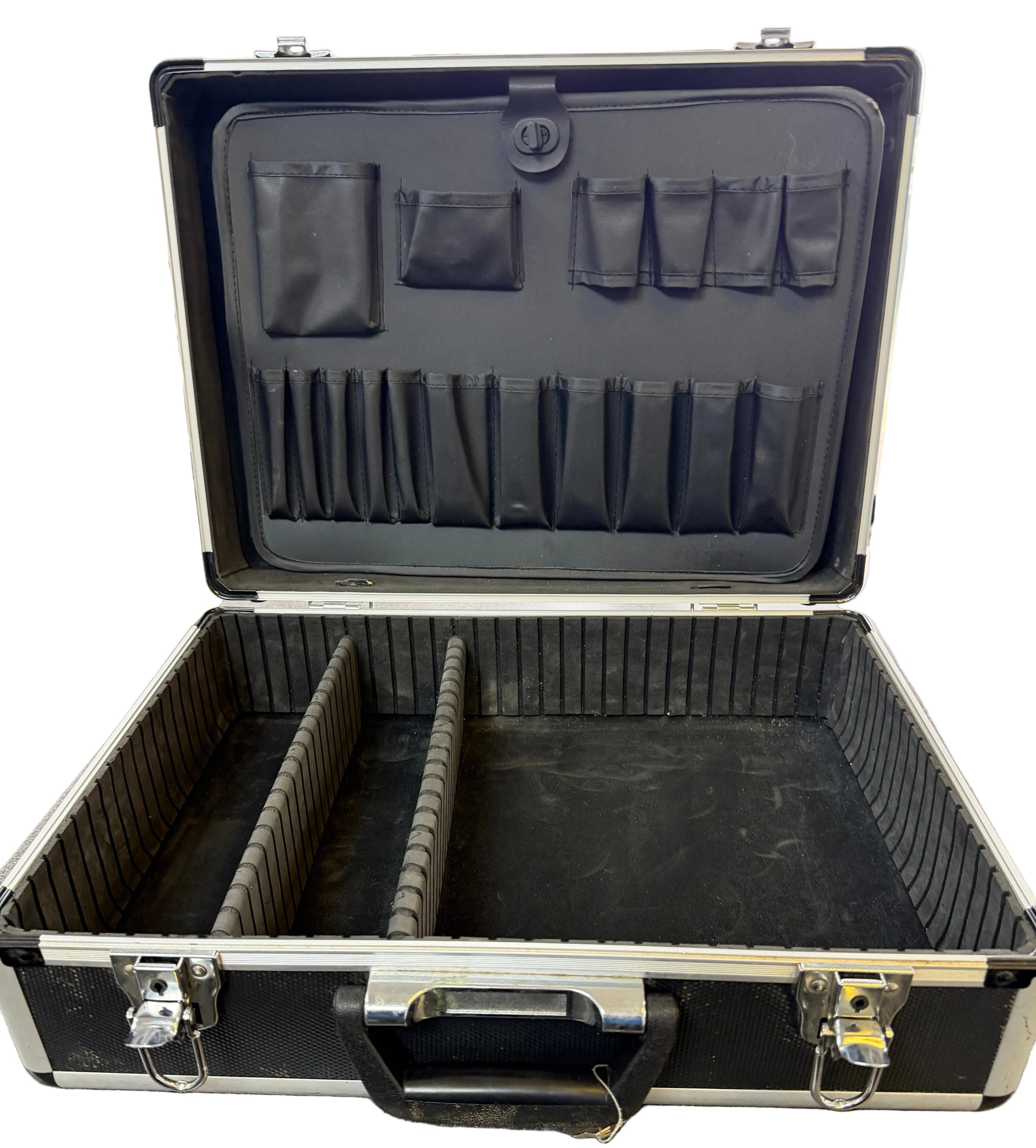 Open black tool case with compartments on a gray floor.