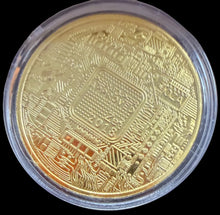 Gold coin with intricate design in a clear holder on a blue background