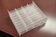 Clear plastic organizer on a wooden surface