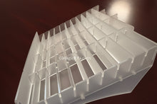 Close-up of a white plastic grid with a dark background