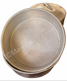 Stack of metal bowls on a wooden surface