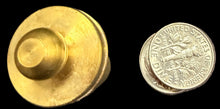 Gold coin and round metal object on a world map