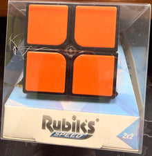 Rubik's Speed cube packaging with orange face pieces on a dark surface