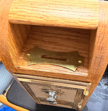 Wooden paper trimmer with a metal blade on a desk