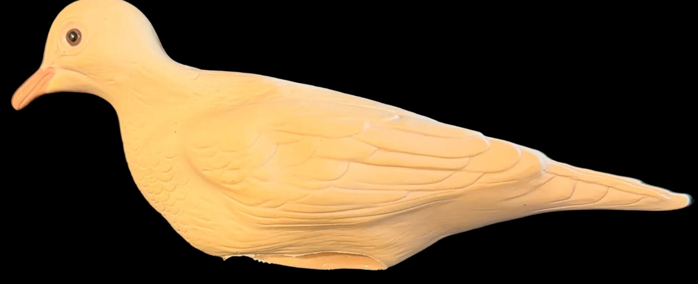 Beige dove figurine on a black background