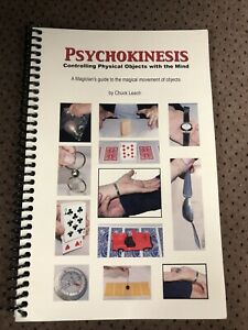 Book titled 'Psychokinesis' with images on the cover, placed on a textured surface.