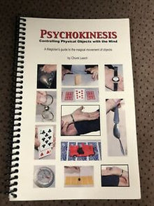 Book titled 'Psychokinesis' with images on the cover, placed on a textured surface.