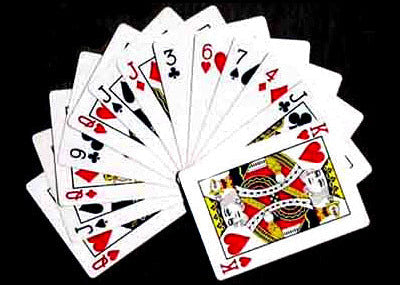 Fanned-out deck of playing cards on a black background