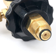 Close-up of a brass and black pressure washer nozzle on a white background