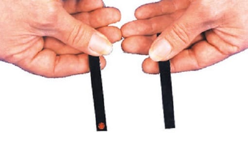 Two hands holding black tubes with a white background