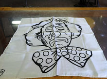 White fabric with black ink drawing of a character on a glass surface
