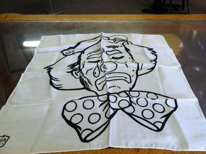 White fabric with black ink drawing of a character on a glass surface