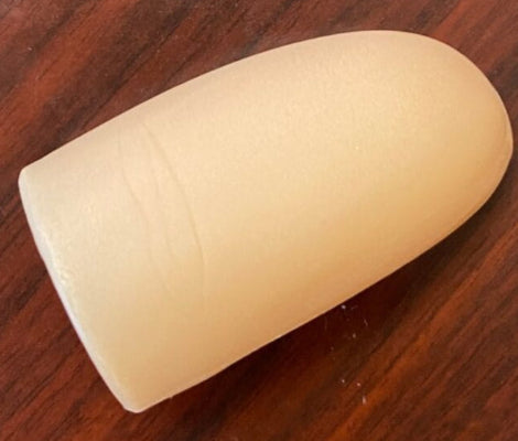 Beige earbud on a wooden surface