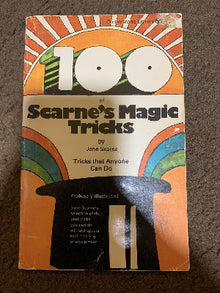 Book titled '101 of Scarne's Magic Tricks' on a textured surface