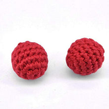 Two red crocheted balls on a white background