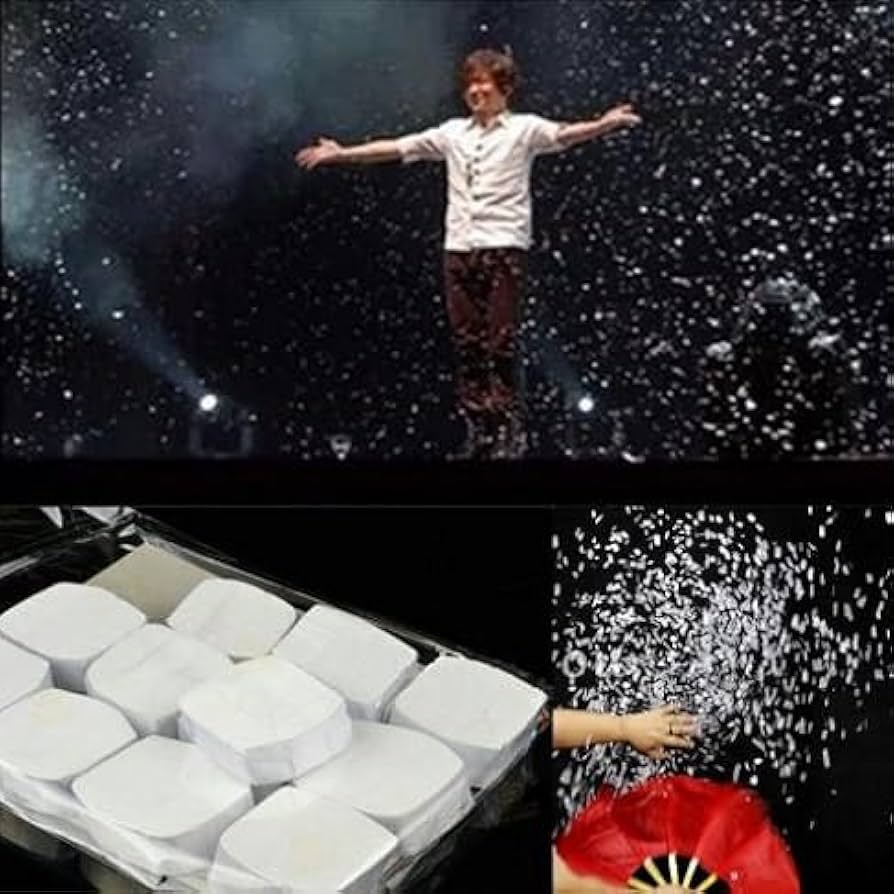 Person floating against a starry space background, with a box of white blocks and a red flower in the foreground.