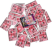 Pink playing cards with black symbols scattered on a white background