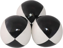 Three black and white juggling balls on a white background