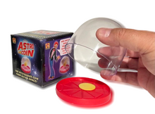 Astro Coin toy with packaging and a hand holding the transparent sphere.