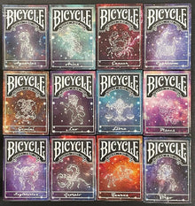 Collection of Bicycle zodiac-themed playing card boxes.