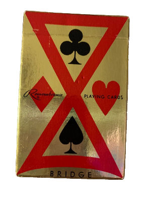 Playing card box with red and gold design featuring card suits on a white background