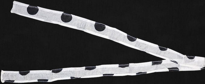 Two polka dot ribbons on a black background