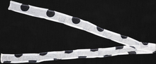 Two polka dot ribbons on a black background