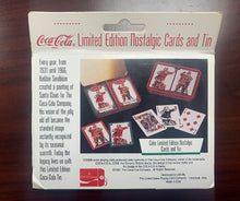 Coca-Cola limited edition nostalgic cards and tin packaging on a wooden surface