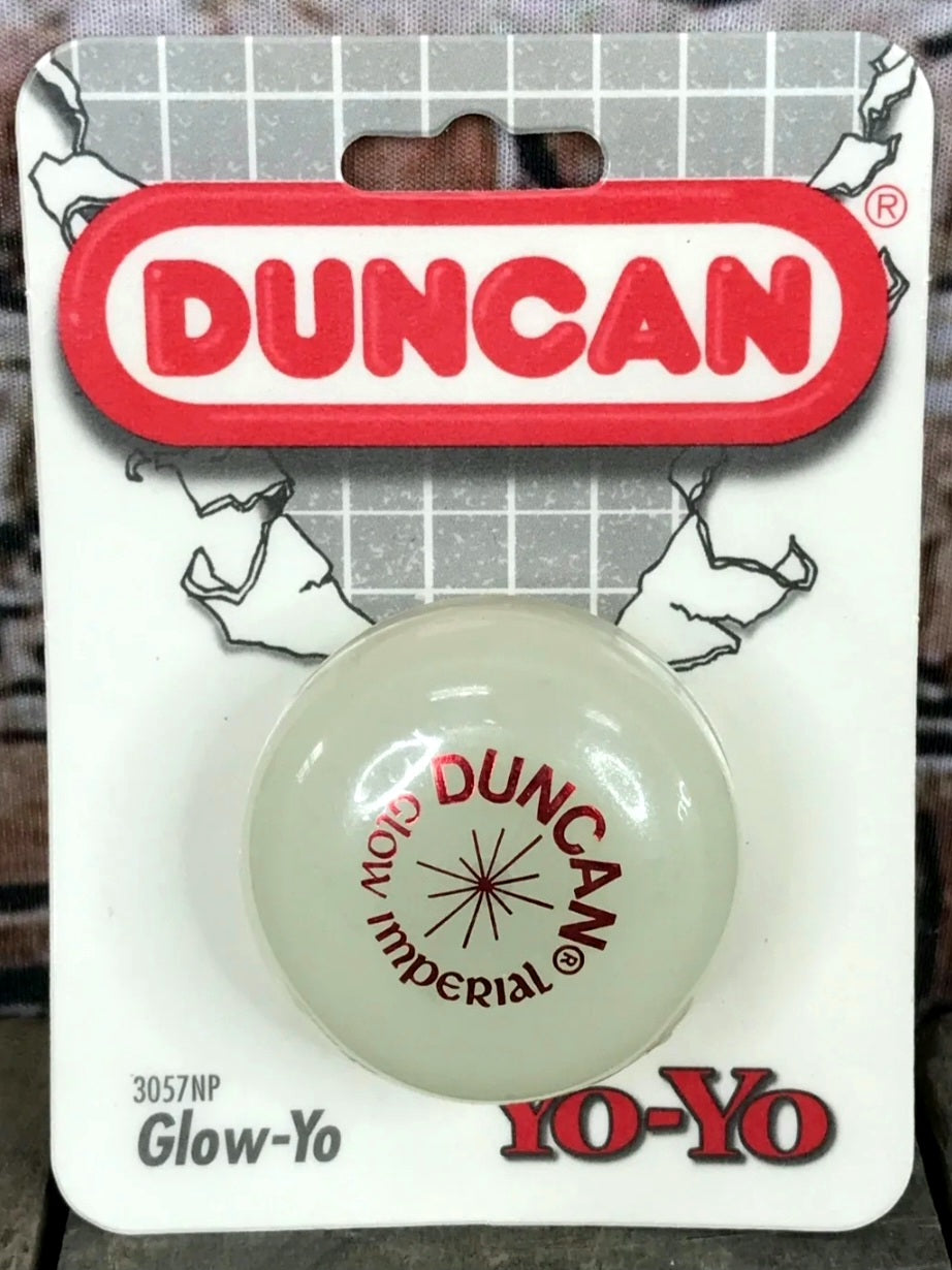 Glow-in-the-dark yo-yo on a Duncan branded card with a grid background