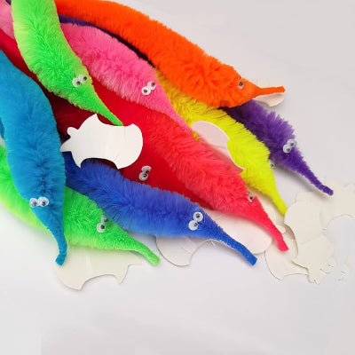 Colorful cat toys shaped like fish on a white background