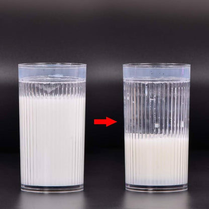Two glasses filled with a layered liquid on a black background