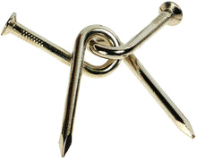 Gold-colored metal nail with a knot design on a white background