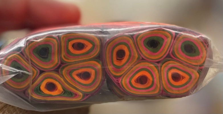 Packaged colorful yarn rolls with a blurred background