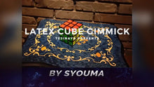 Rubik's Cube on a decorative mat with 'Latex Cube Gimmick' text and 'Syouma' branding.