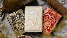 Three playing card boxes labeled 'Prestige' in gold, white, and red on a textured surface.