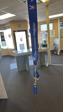 Blue lanyard with a tag in an indoor setting, possibly an office or public building.