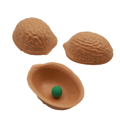 Three brown walnut-shaped toys with a green ball inside one of them on a white background.