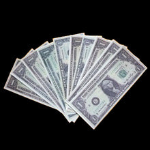 Fanned-out arrangement of U.S. dollar bills on a black background