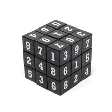 Black cube with white numbers on a white background