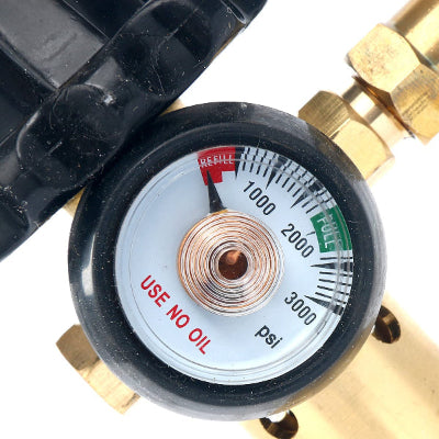 Pressure gauge with brass connections on a white background