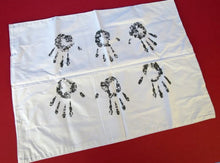 White paper with black handprints on a red background