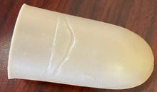 White cylindrical object on a wooden surface