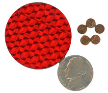 Red textured circular object next to coins and a coin on a white background
